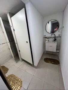 a bathroom with a door and a mirror and a sink at Luxfran in Uspallata