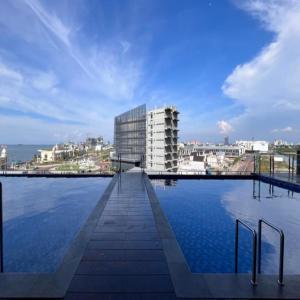 a large pool of water in front of a building at Delf Apartement Cpi Mewah By Selfiyani in Makassar