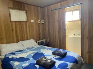 a bedroom with a bed with two towels on it at Miners Rest Units in Mount Magnet