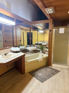a bathroom with two sinks and a large mirror at Riverview Lodge in Dryden +9 photos
