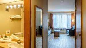 a bathroom with a sink and a living room at Cahilty #214 home in Sun Peaks