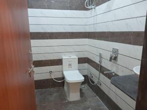 a bathroom with a toilet and a sink at HOTEL SHREE JMM Mount View in Udaipur