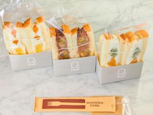 three sandwiches in plastic bags on a counter at HOTEL THE LEBEN OSAKA in Osaka