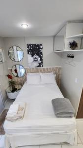 a large white bed in a small room with mirrors at Studio Costa a Mar in Guarapari +20 photos