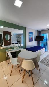 a living room with a table and chairs at Studio Costa a Mar in Guarapari