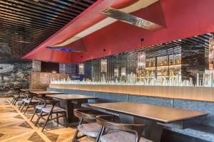 a row of tables and chairs in a restaurant at Mercure Beijing Dongzhimen in Beijing