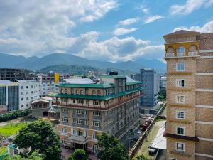 a building in a city with mountains in the background at Studio in Dehradun in Dehradun