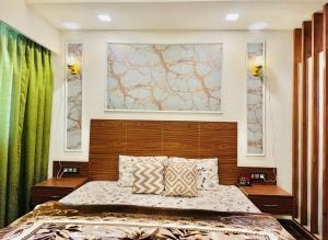 a bedroom with a bed and two windows with green curtains at Studio in Dehradun in Dehradun