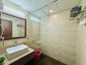 a bathroom with a sink and a glass shower at Studio in Dehradun in Dehradun +30 photos
