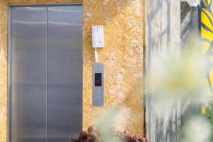 a metal door on the side of a building at Xavia Hotel in Quy Nhon +43 photos