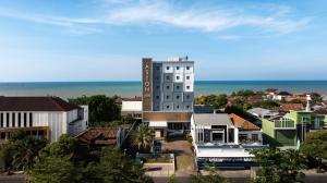 a tall building in a city next to the ocean at Aston Inn Rembang in Rembang