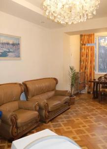 a living room with a couch and a chandelier at Nice apartment nearby Garegin Nzhdeh metro, Yerevan in Yerevan