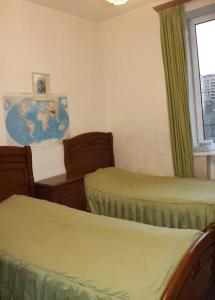 a room with two beds and a window with a map at Nice apartment nearby Garegin Nzhdeh metro, Yerevan in Yerevan
