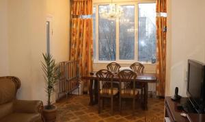 a dining room with a table and chairs and a window at Nice apartment nearby Garegin Nzhdeh metro, Yerevan in Yerevan