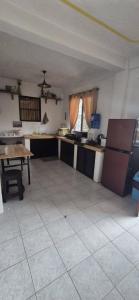 a large kitchen with a table and a refrigerator at White Beach Villa in Dauis