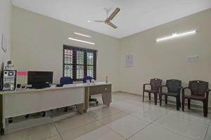 an office with a desk and chairs in a room at Hotel O Skywind in Trivandrum