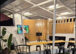 a conference room with a table and chairs and a screen at White Beach Villa in Dauis +25 photos