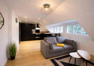 a living room with a couch and a table at White House Dhavernas - Résidence Privée - Amiens - Parking Gratuit in Amiens