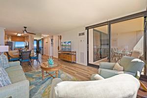 a living room with two couches and a table at Mahana 718 in Lahaina