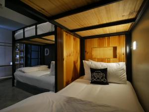 two beds in a room with two bunk beds at Blu Monkey Hotel Surat Thani in Suratthani