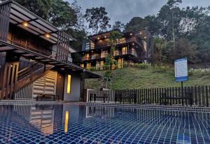 a house on top of a hill with a swimming pool at Lilla Waterfall Retreat - Sg Lembing, Kuantan Formerly Known as Casa Hill Resort in Sungai Lembing