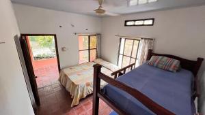 a small bedroom with a bed and a window at Eden Garden in Santa Marta