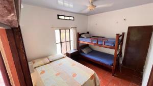 a bedroom with two bunk beds and a window at Eden Garden in Santa Marta