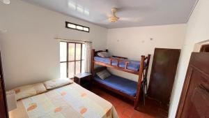 a bedroom with two bunk beds and a window at Eden Garden in Santa Marta