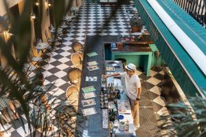 a man standing at a table in a restaurant at Quba by Montraj Pattaya, previously The Quba Hotel Pattaya in Pattaya +53 photos