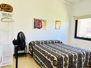 a bedroom with a bed with a blanket on it at LA ESQUINA DE LA FLOR in Campo Quijano +10 photos