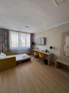a hotel room with a bed and a desk at Carina Hotel in Tczew
