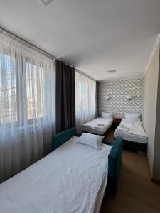 a room with two beds and a window at Carina Hotel in Tczew +55 photos