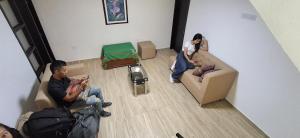 two people sitting on a couch in a living room at Hotel San Marcos Las Lajas in Ipiales +33 photos