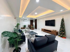 a living room with a christmas tree and a tv at The Nest Bed and Breakfast - Kalibo in Kalibo