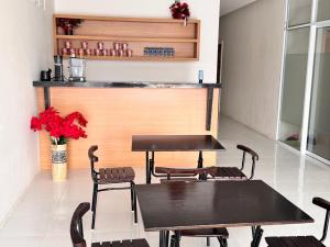 a restaurant with a table and chairs and a counter at G-House-2 in Singkawang