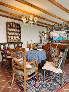 a kitchen with a table and chairs in a room at SIA Home in Da Lat