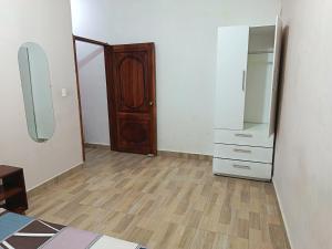 an empty room with a dresser and a closet at Departamento amoblado in Nueva Loja +3 photos