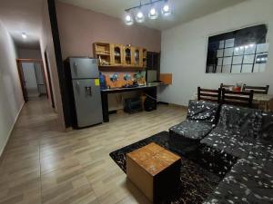 a living room with a couch and a refrigerator at Departamento amoblado in Nueva Loja