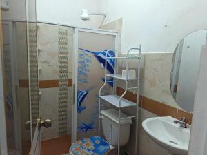a bathroom with a shower and a toilet and a sink at Departamento amoblado in Nueva Loja