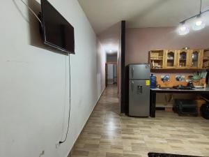 a kitchen with a refrigerator and a desk in a room at Departamento amoblado in Nueva Loja