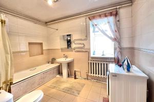 a bathroom with a sink and a toilet and a bath tub at BTMongolia Guest house Tour Operator in Ölgiy +22 photos