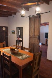 a dining room table with a basket of fruit on it at El Bosque de Simba - Cabaña in La Estancia