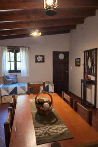 a dining room with a table with a basket on it at El Bosque de Simba - Cabaña in La Estancia