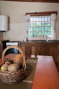 a basket of vegetables sitting on a table in a kitchen at El Bosque de Simba - Cabaña in La Estancia