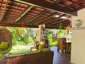 an outdoor living room with chairs and a table at La Mancha - luxurious Mediterranean styled home in Southbroom