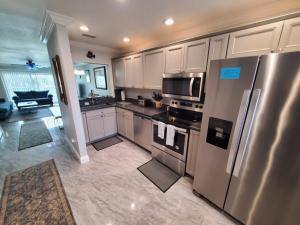 a kitchen with a stainless steel refrigerator and appliances at Summerhouse 218 condo in St. Augustine