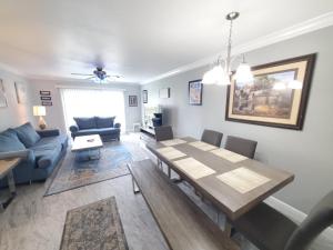 a living room with a table and a dining room at Summerhouse 218 condo in St. Augustine
