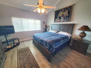 a bedroom with a bed and a ceiling fan at Summerhouse 218 condo in St. Augustine +18 photos