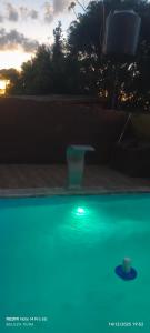 a vase sitting on a patio with a green light at LUZ BELLA 2 in Oberá