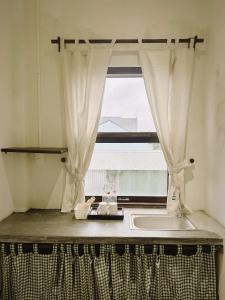 a bathroom with a sink and a window at Jin homestay in Thôn Lại Thê +16 photos